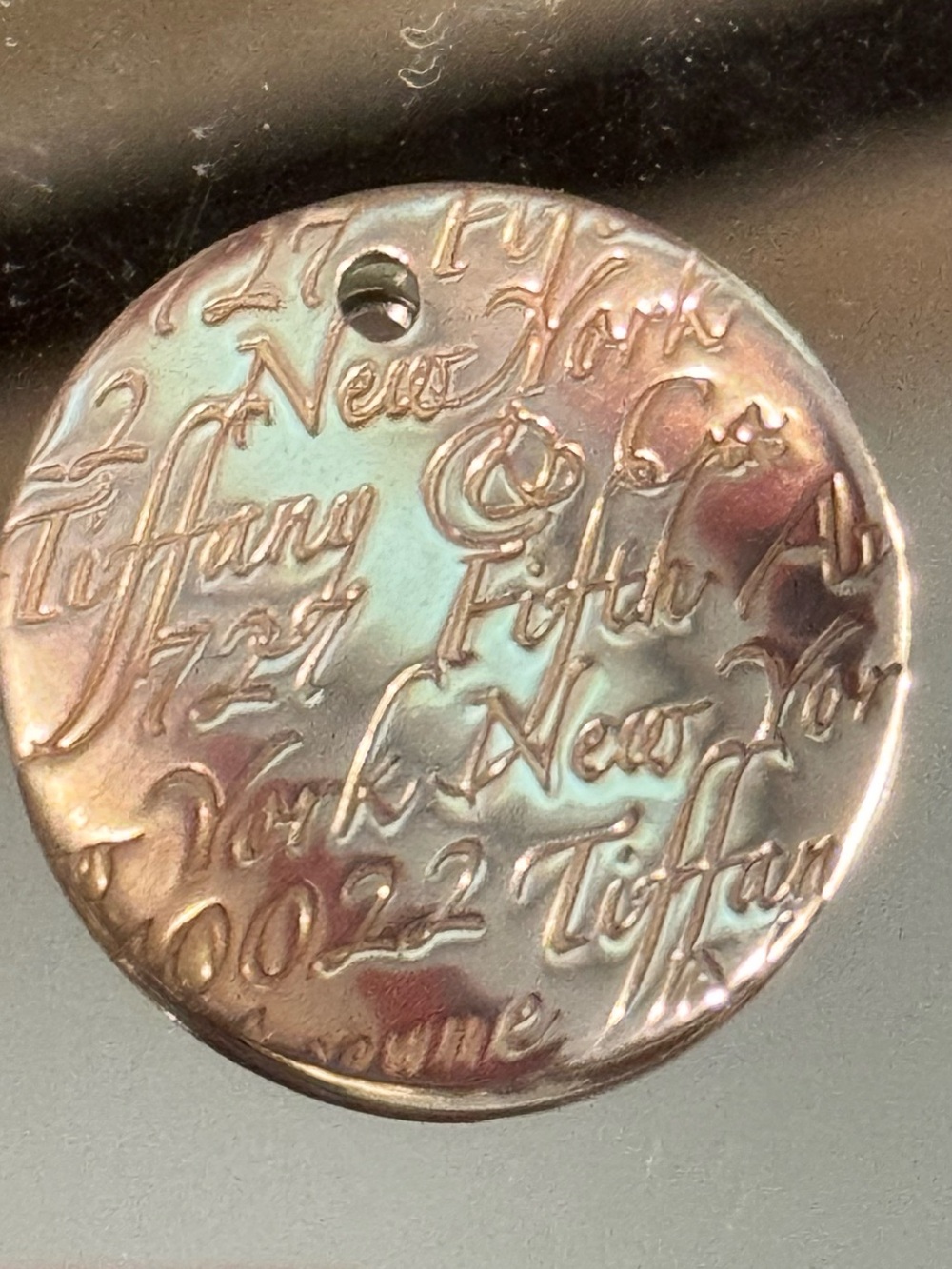Tiffany & Co. Iridescent Silver Round Engraved Pendant Wave Pendant.